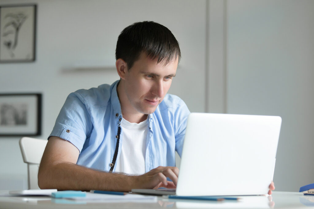 Мужчина работает с Jira на компьютере